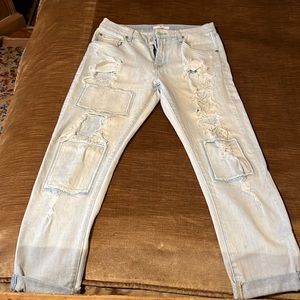 Woman’s jeans size 27 white washed distressed with patches and frayed spots